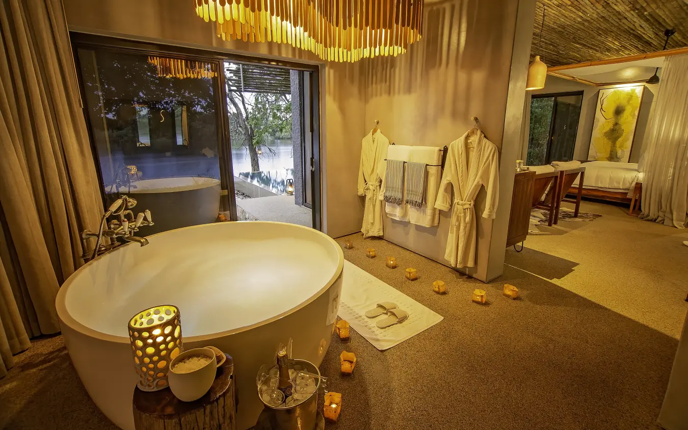 Luxurious spa bathroom with freestanding bathtub and ambient lighting, Matetsi River Lodge, Victoria Falls, Zimbabwe