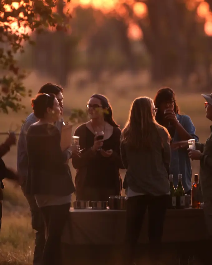 Guests gathered at sunset enjoying drinks and conversation