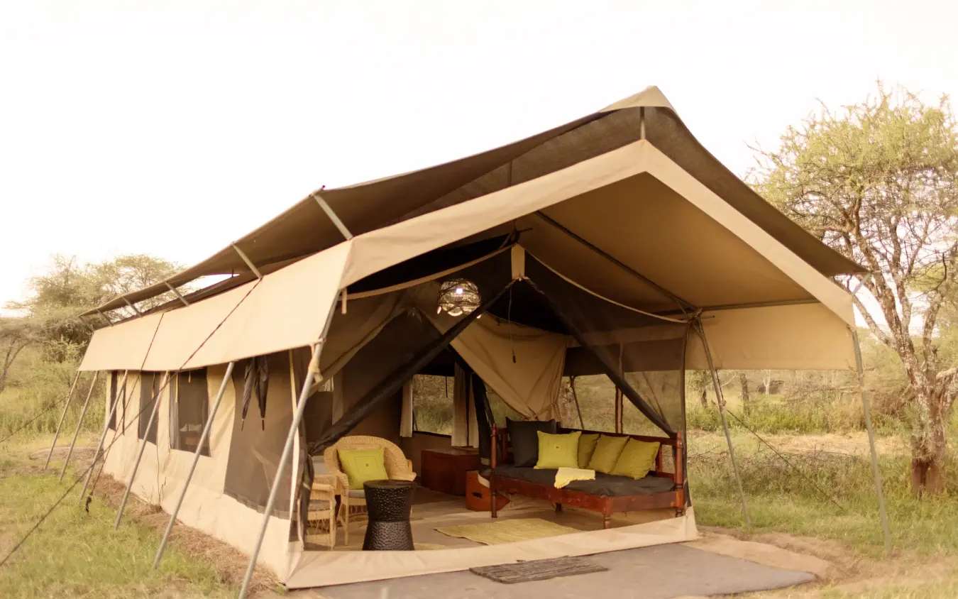 Luxury canvas safari tent with open-air bedroom and lounge area, Ndutu Wilderness Camp, Serengeti National Park, Tanzania