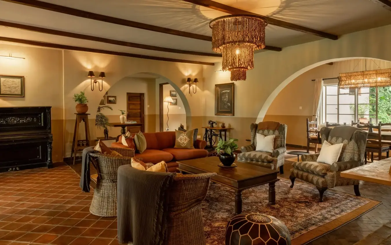 Luxury lounge interior with warm earth tones and arched doorways, Rivertrees Country Inn, Arusha, Tanzania