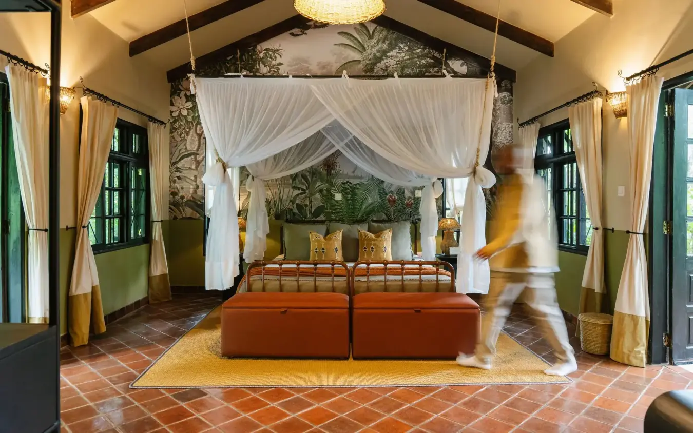 Luxury bedroom with four-poster canopy bed and tropical botanical décor, Rivertrees Country Inn, Arusha, Tanzania
