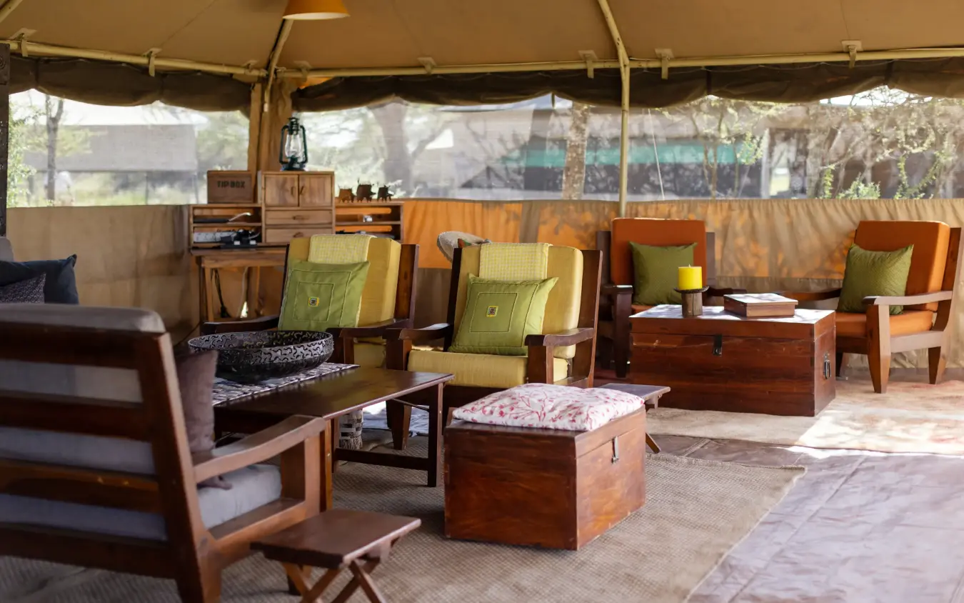 Safari lodge lounge tent with wooden furniture and canvas walls, Serengeti North Wilderness Camp, Serengeti National Park, Tanzania