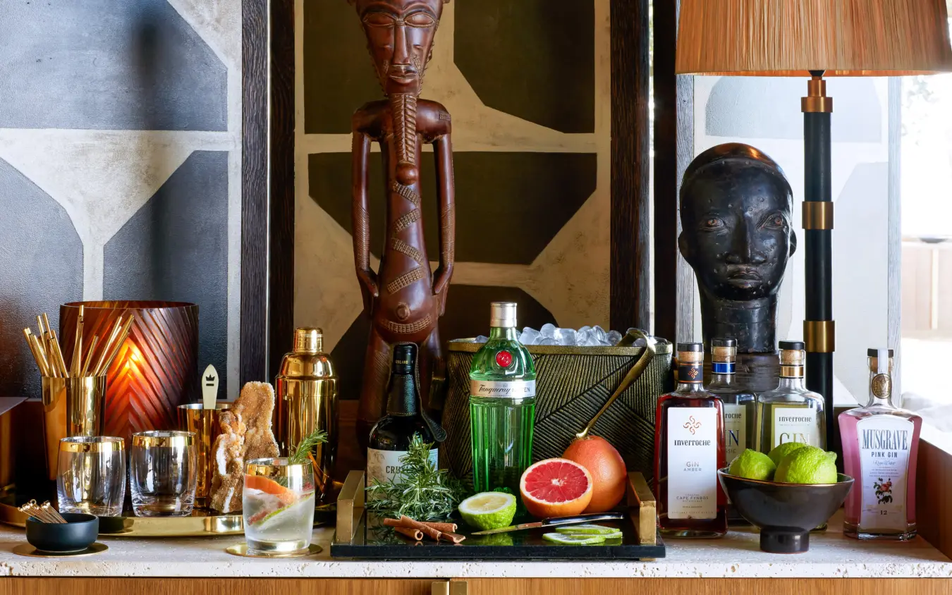 Luxury bar display with African sculptures and spirits bottles, Singita Malilangwe House, Gonarezhou & Malilangwe, Zimbabwe