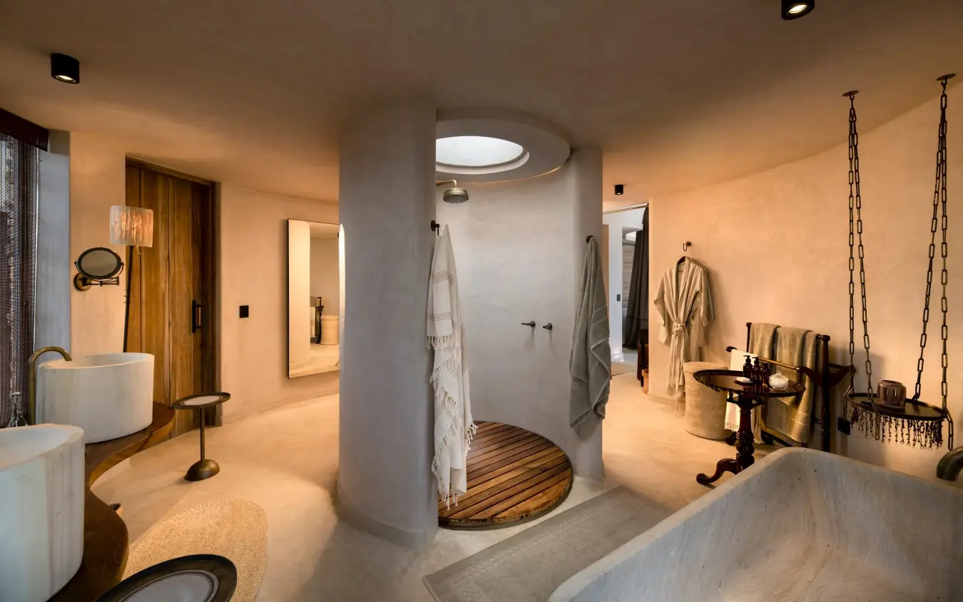 Luxury spa bathroom with circular shower, freestanding tubs and hanging swing, Suyian Lodge, Laikipia Highlands, Kenya