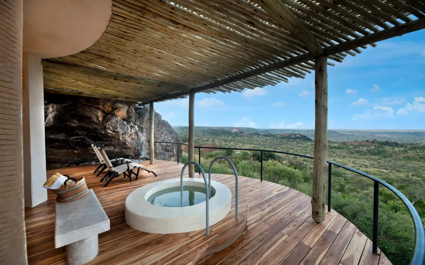 Elevated deck with circular soaking tub overlooking expansive savanna landscape, Suyian Lodge, Laikipia Highlands, Kenya