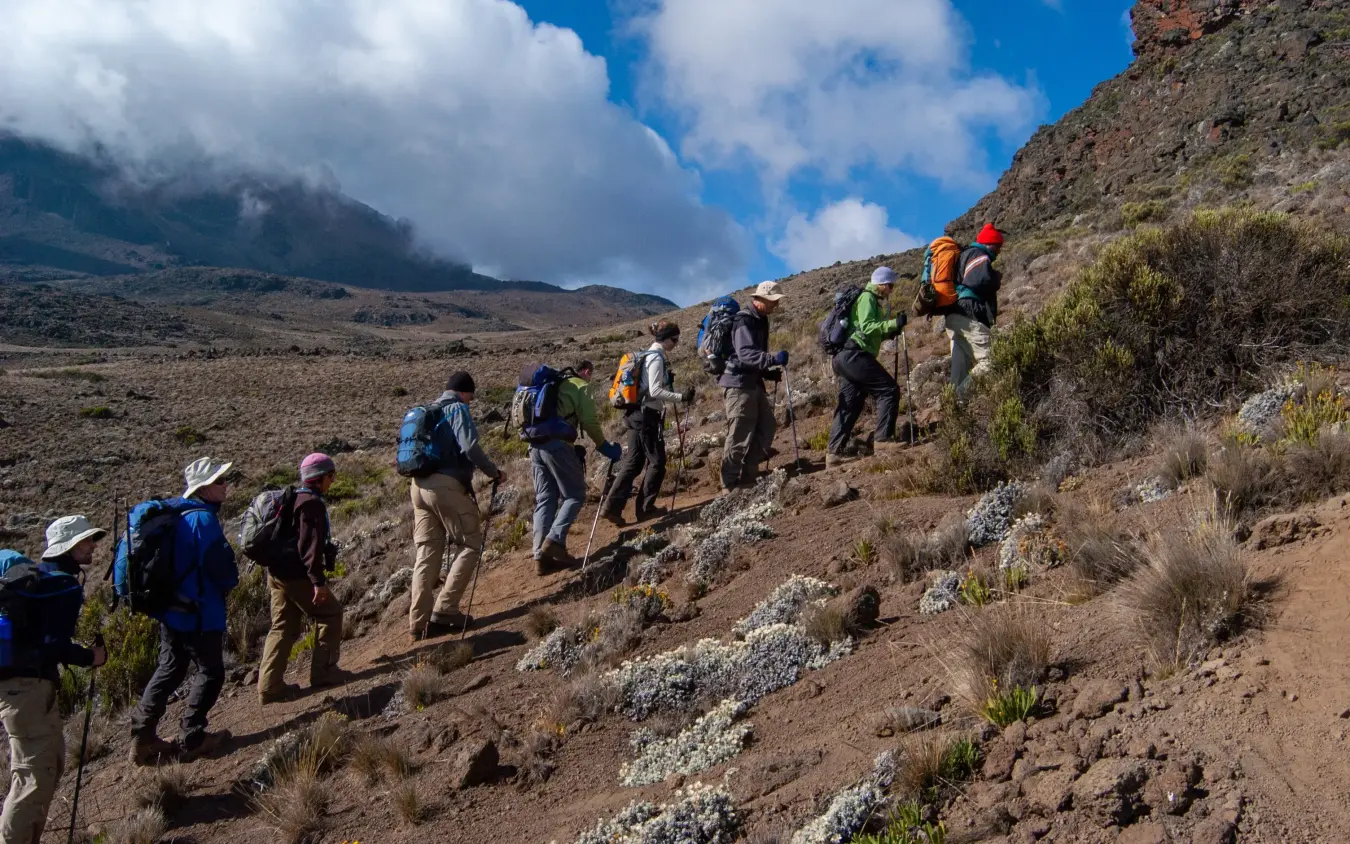 Group of hikers trekking up a rocky trail on Kilimanjaro Tanzania