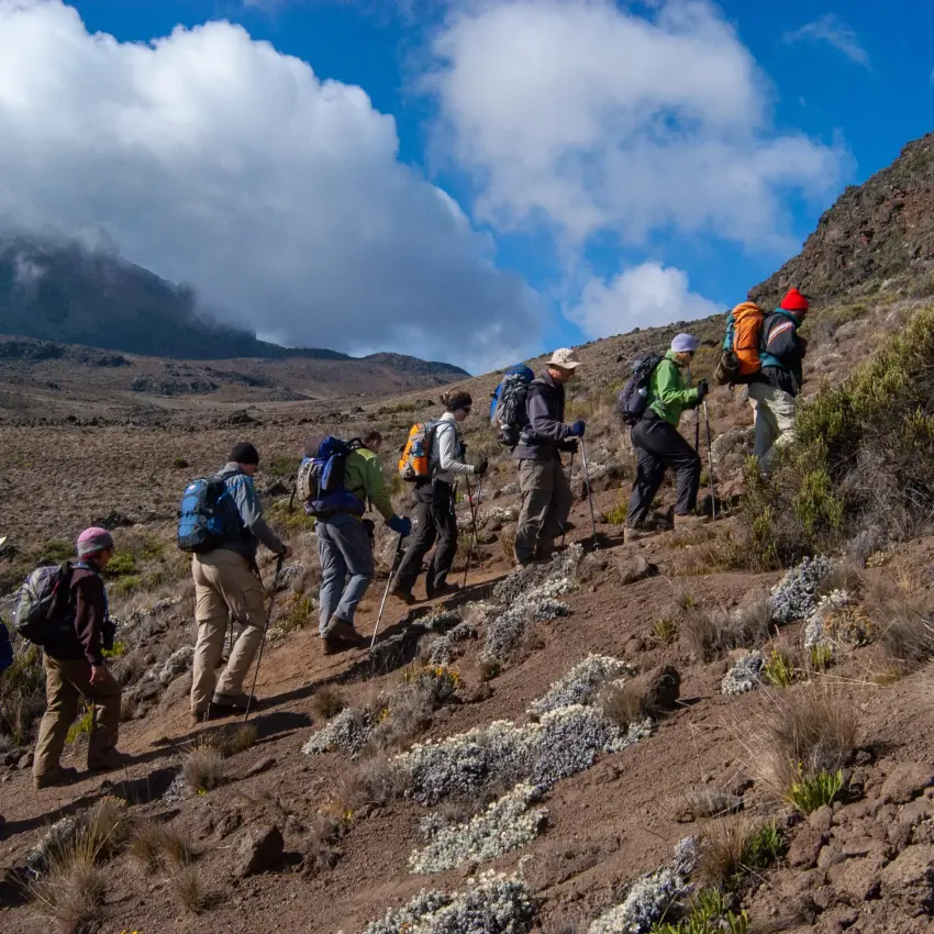 Group of hikers trekking up a rocky trail on Kilimanjaro Tanzania