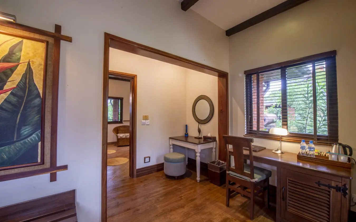 Bedroom suite with wooden furnishings and garden views through shuttered windows, The Retreat at Ngorongoro, Ngorongoro Crater, Tanzania