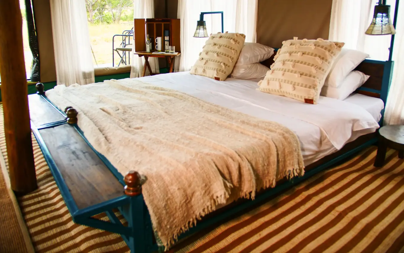 Bedroom with four-poster bed and natural light from windows