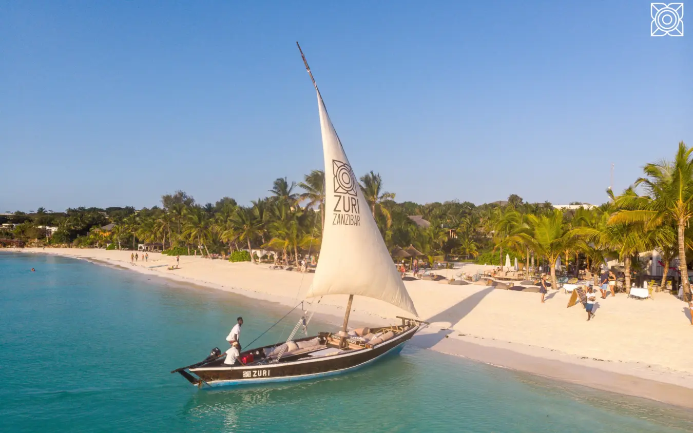 Traditional sailing dhow beached on turquoise water, Zuri Zanzibar, Zanzibar & Pemba, Tanzania