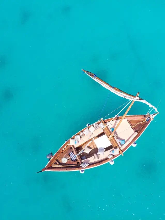 Traditional wooden dhow anchored in turquoise coastal waters, Zuri Zanzibar, Zanzibar & Pemba, Tanzania