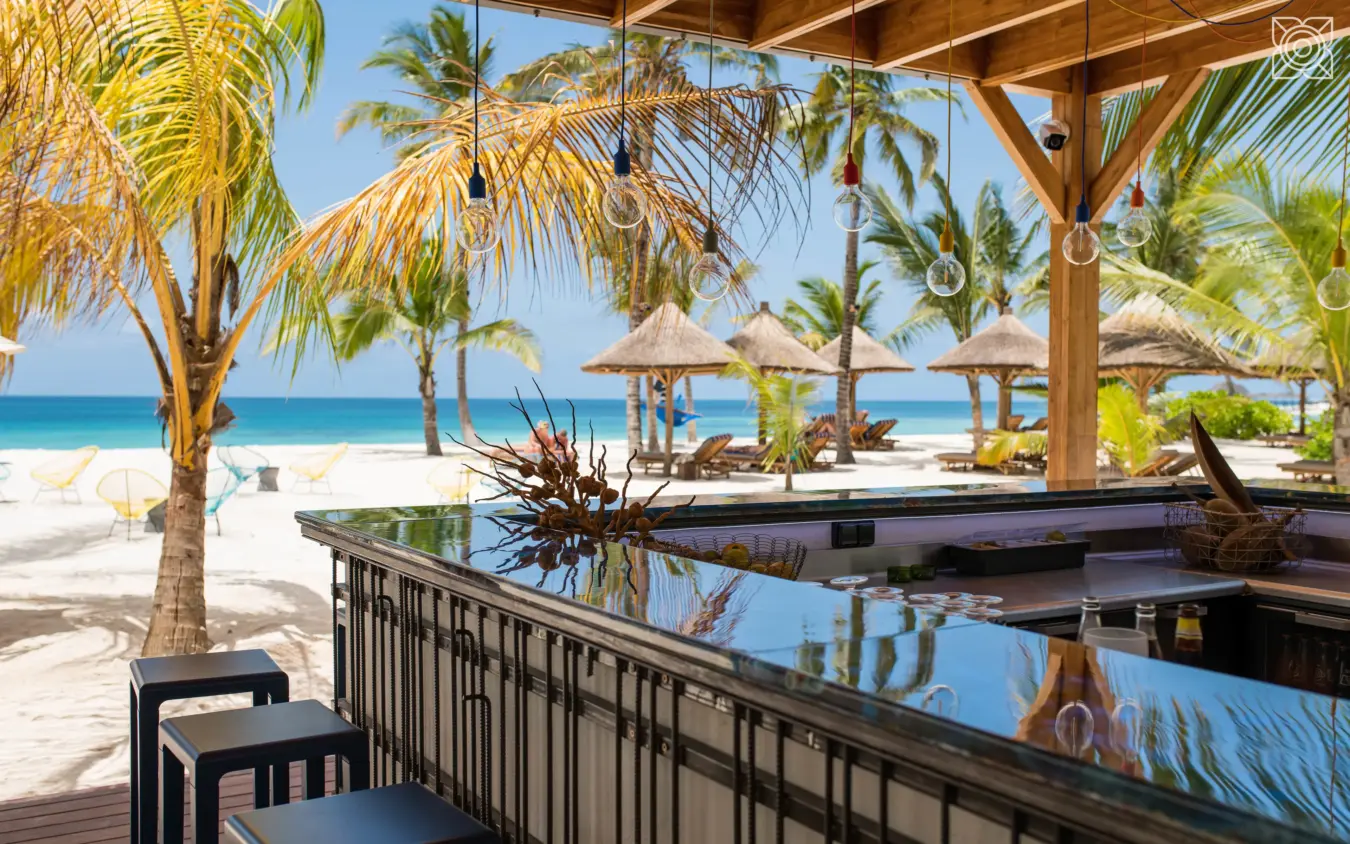 Beachfront dining deck overlooking ocean and palm trees, Zuri Zanzibar, Zanzibar & Pemba, Tanzania