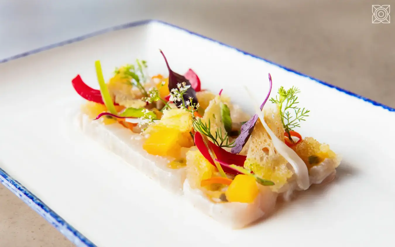 Plated seafood dish with colorful vegetable garnishes and microgreens, Zuri Zanzibar, Zanzibar & Pemba, Tanzania