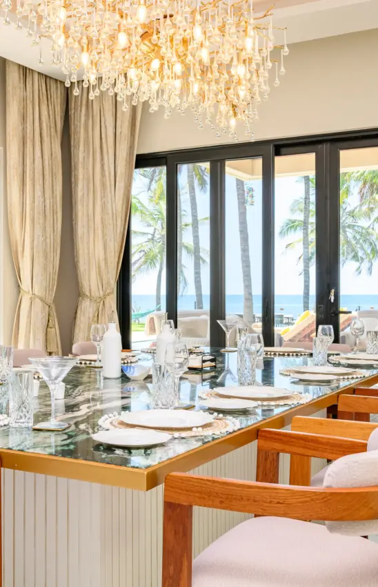 Dining room with ocean view through glass doors and chandelier overhead, Bahari Bliss, Kilifi, Kenya