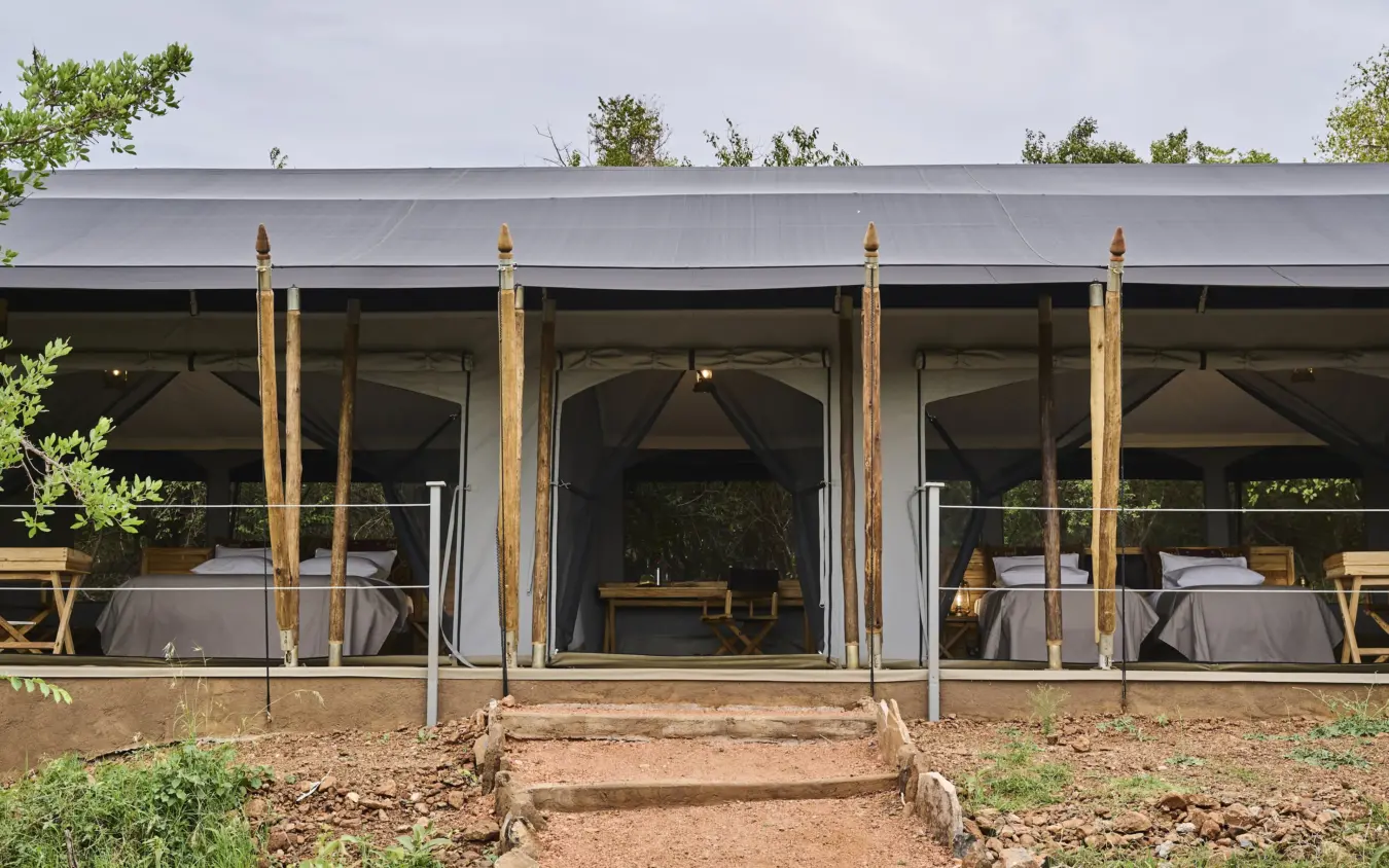 Safari lodge pavilion with open sides and canvas drapes overlooking bushland, Basecamp Wilderness, Maasai Mara, Kenya