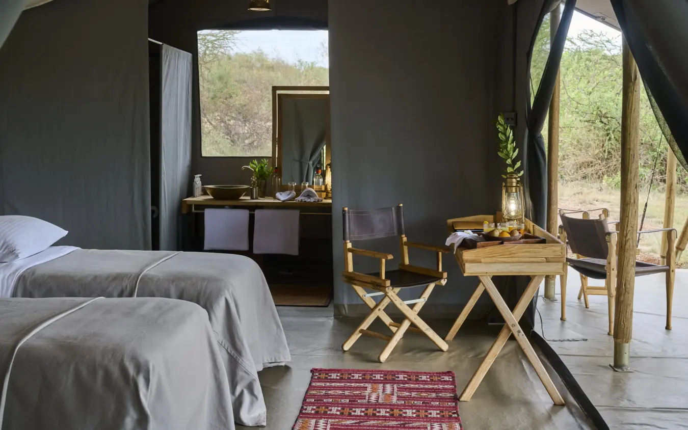 Luxury safari tent bedroom with wooden furnishings and savanna views, Basecamp Wilderness, Maasai Mara, Kenya