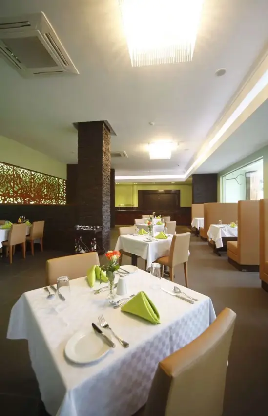 Fine dining restaurant with lime green accents and decorative wooden screen, Best Western Premier Garden Hotel Entebbe, Entebbe and Kampala, Uganda