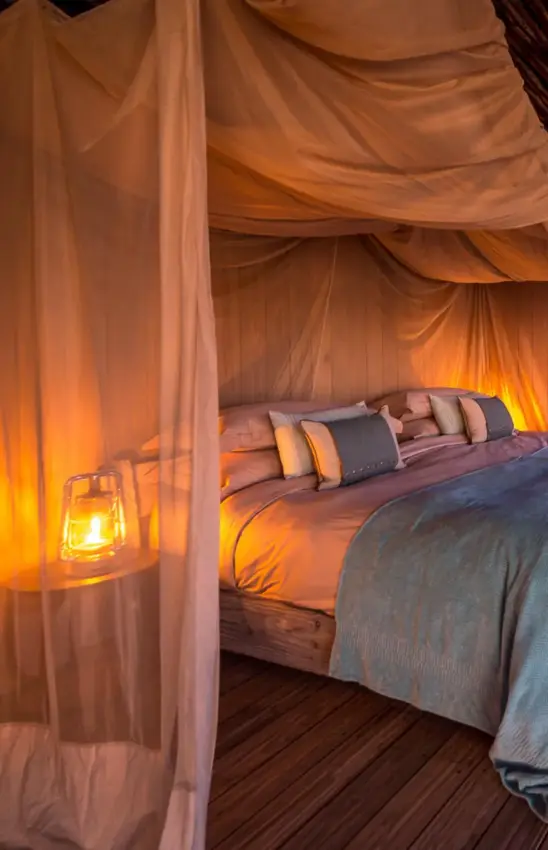 Bedroom deck overlooking water at sunset with canopy, Savuti Camp, Linyanti Wildlife Reserve, Botswana