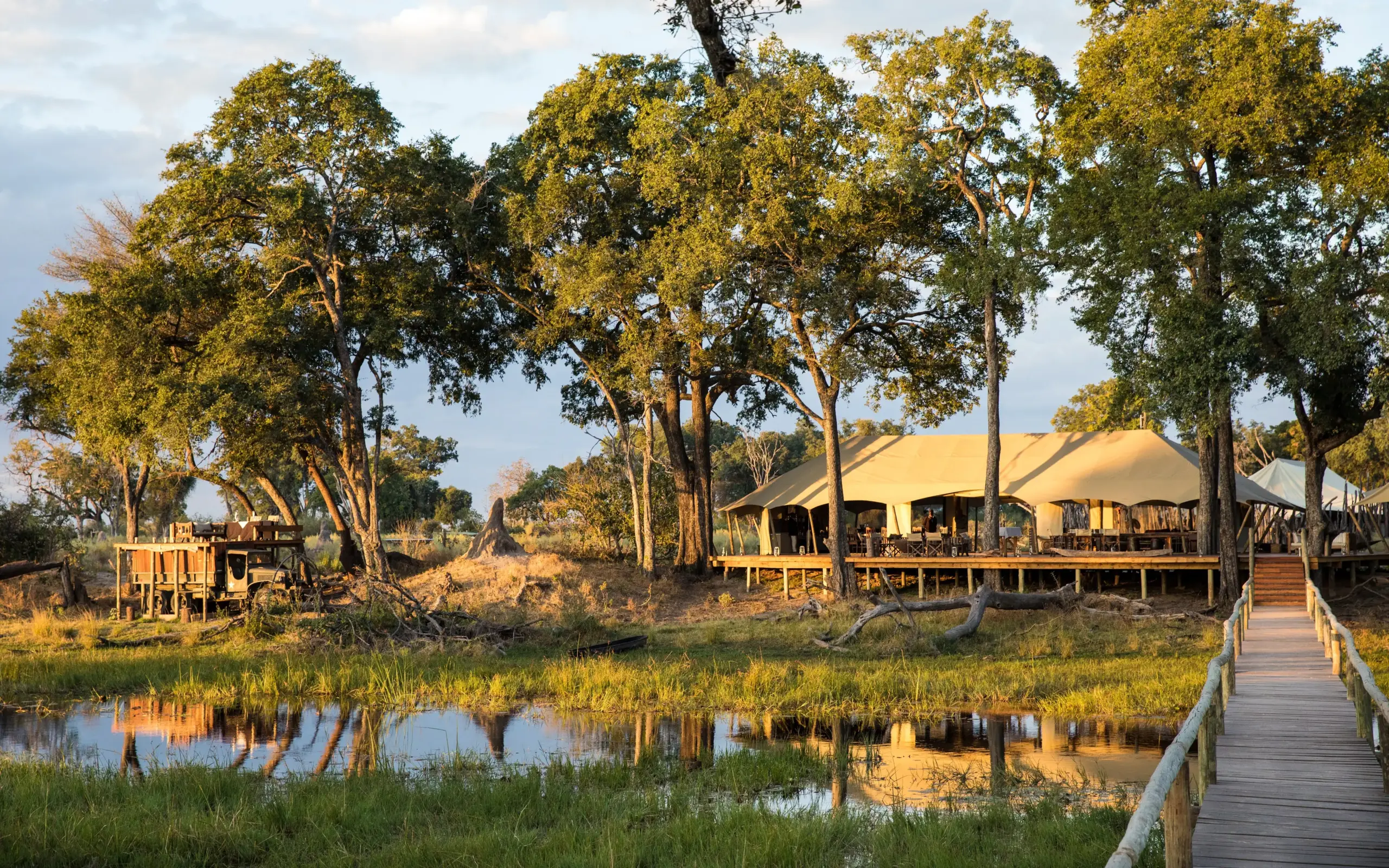 Luxury safari camp with tented accommodation beside floodplain waterhole, Duba Explorers Camp, The Okavango Delta, Botswana