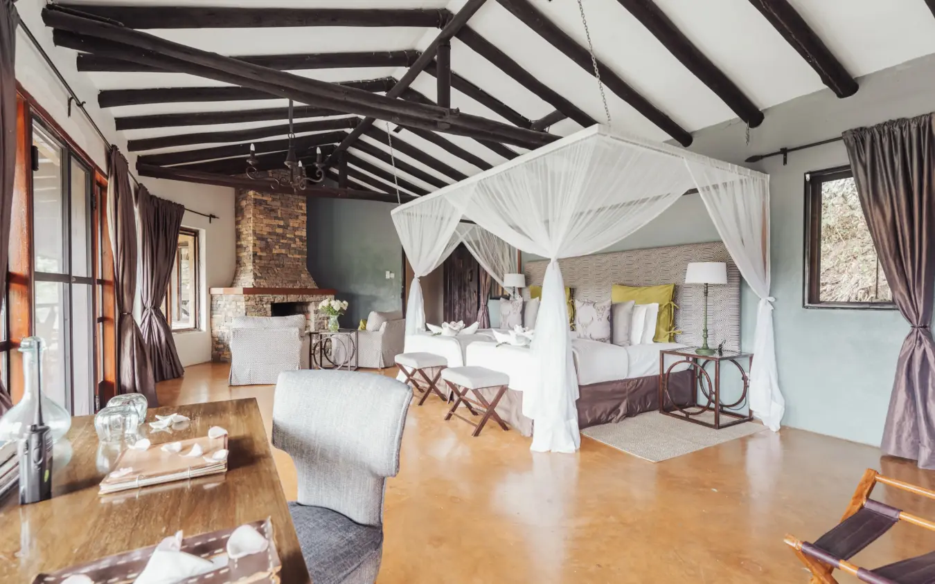 Luxury bedroom suite with canopy bed and exposed beam ceiling in safari lodge, The Emakoko, Nairobi, Kenya