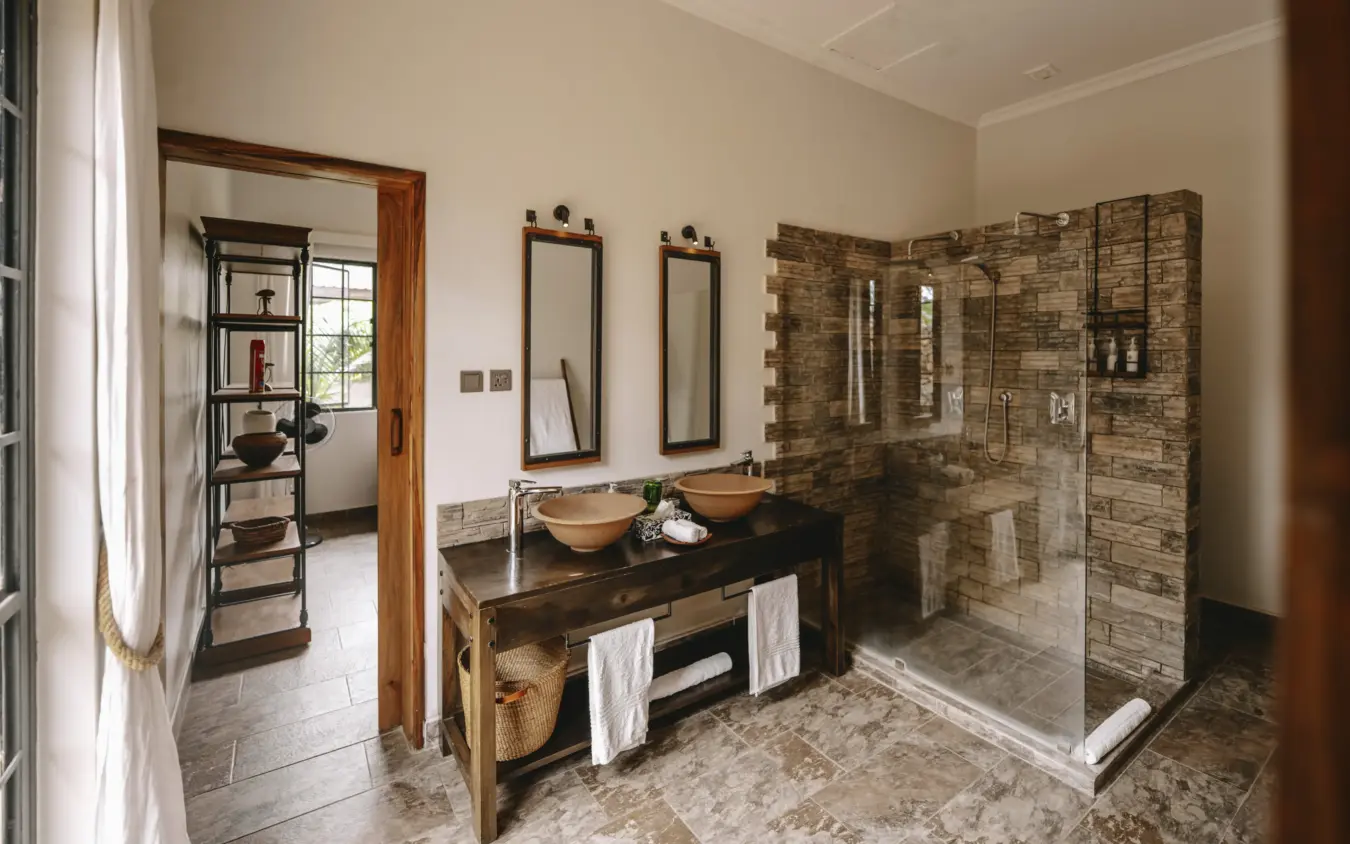 Luxury bathroom with double vessel sinks and walk-in stone shower, Hamerkop House, Arusha, Tanzania