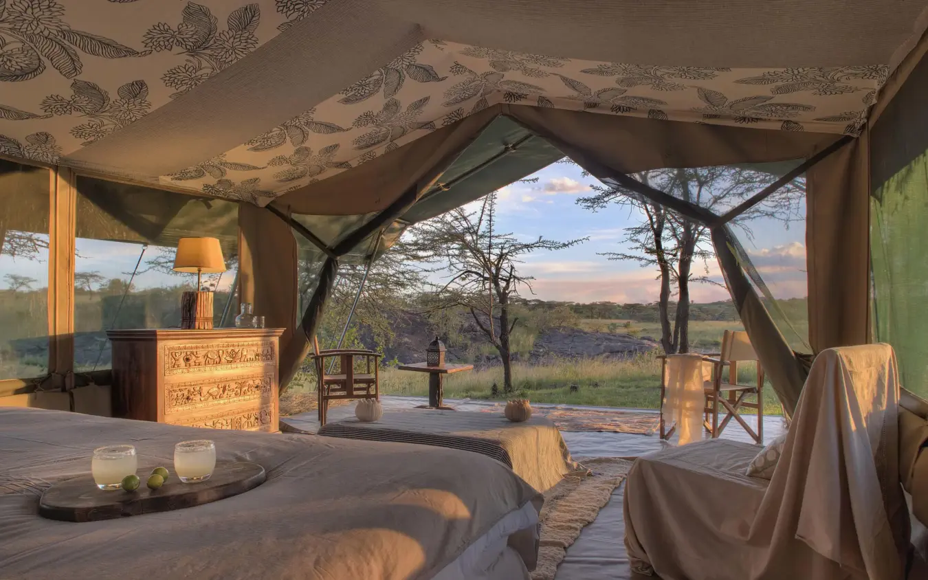 Luxury safari tent interior with savanna landscape view at dusk, Hemingways River Camp Mara, Maasai Mara, Kenya