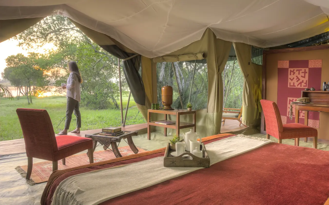 Luxury safari tent interior with open sides overlooking grassland at dusk, Kicheche Laikipia, Laikipia Highlands, Kenya