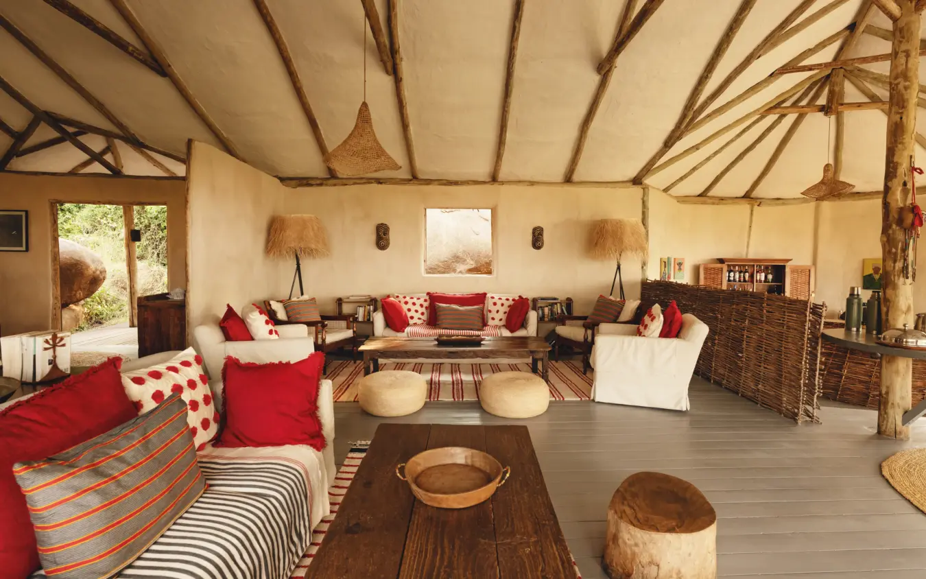 Luxury canvas tent interior with red accents and natural wood furnishings, Lamai Serengeti, Serengeti National Park, Tanzania