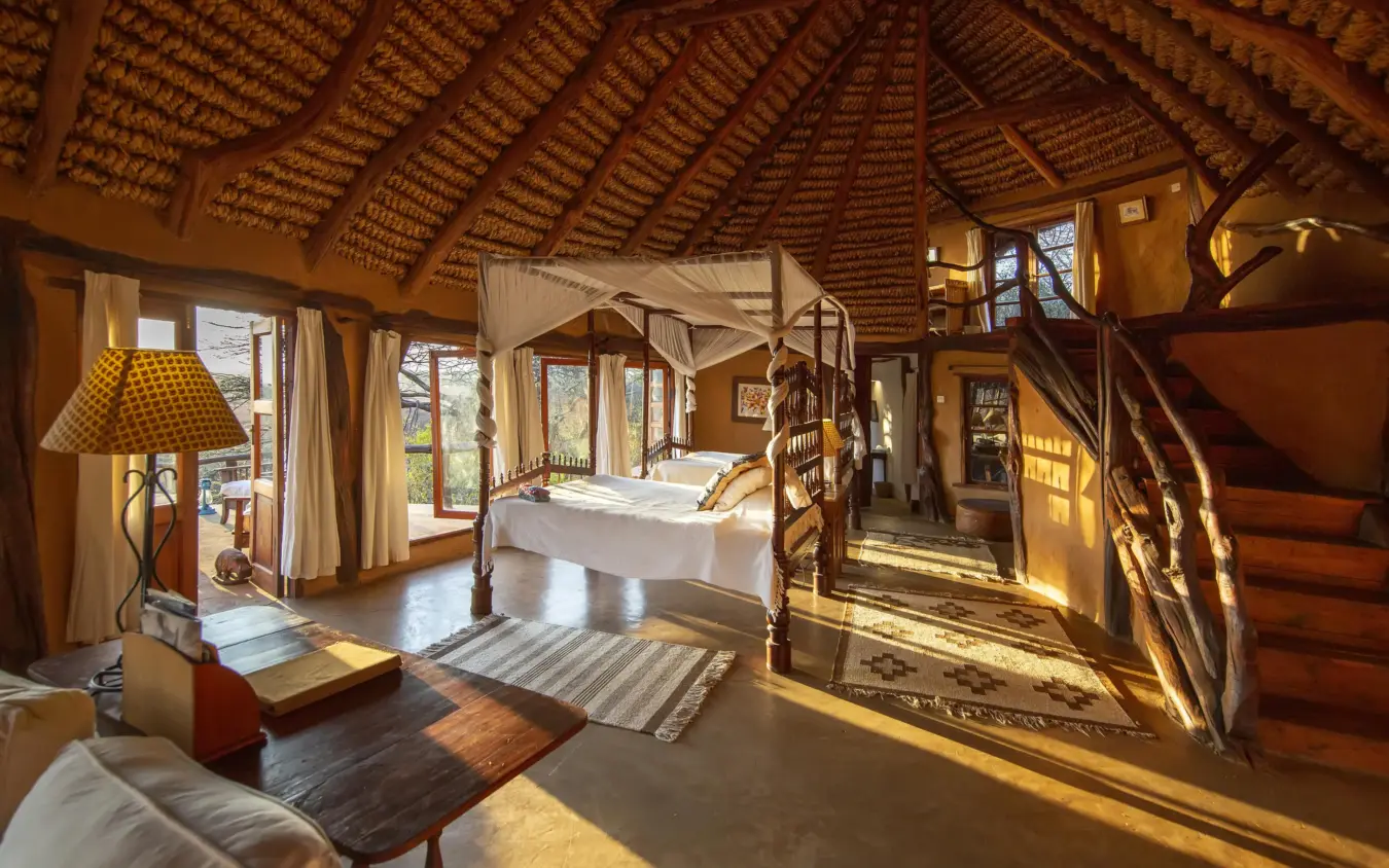 Spacious bedroom with four-poster bed and natural light, Lewa Wilderness, Laikipia Highlands, Kenya