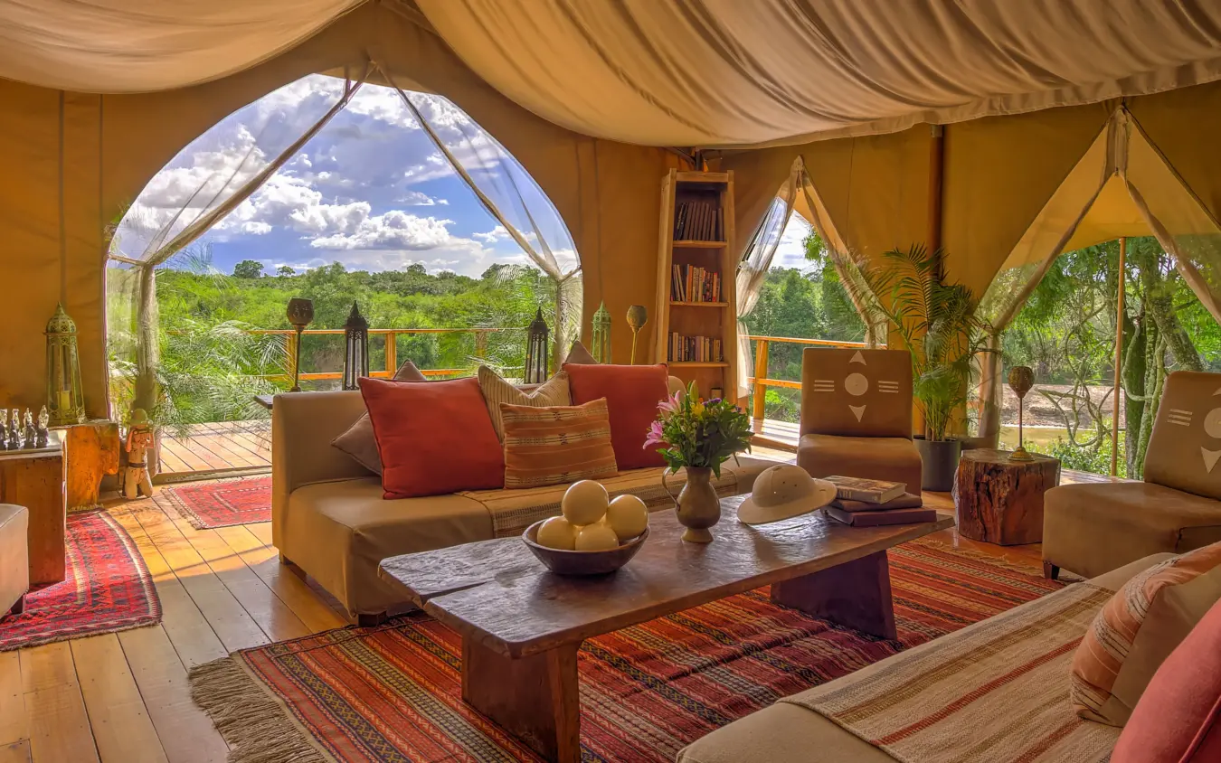Luxury safari tent interior with open views of woodland landscape, Naibor Camp, Maasai Mara, Kenya