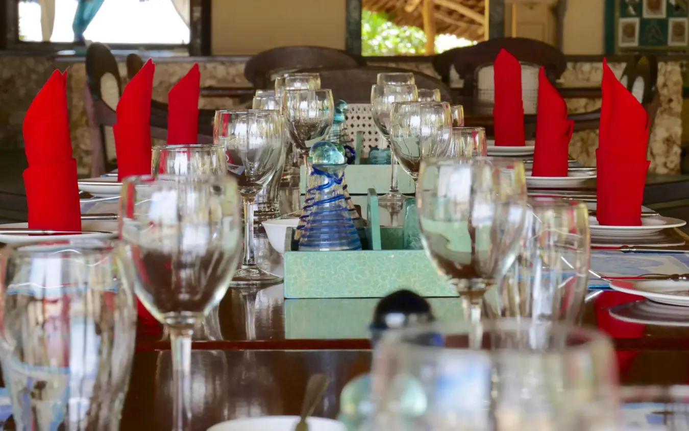 Formal dining table set with red candles and glassware, Manda Bay, Lamu Archipelago, Kenya