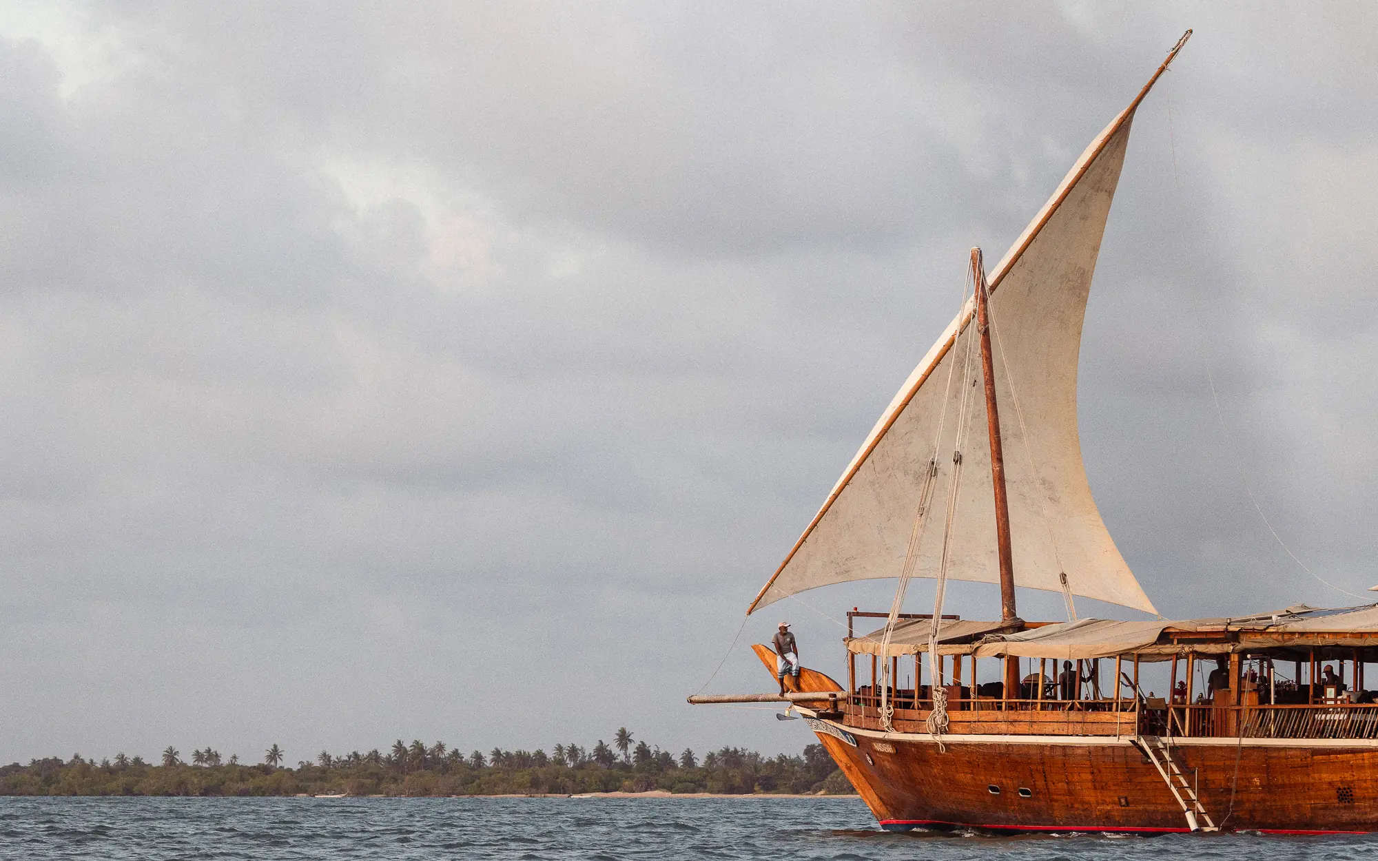 Wooden sailing dhow with canvas sail on coastal waters, NaiSabah, Lamu Archipelago, Kenya