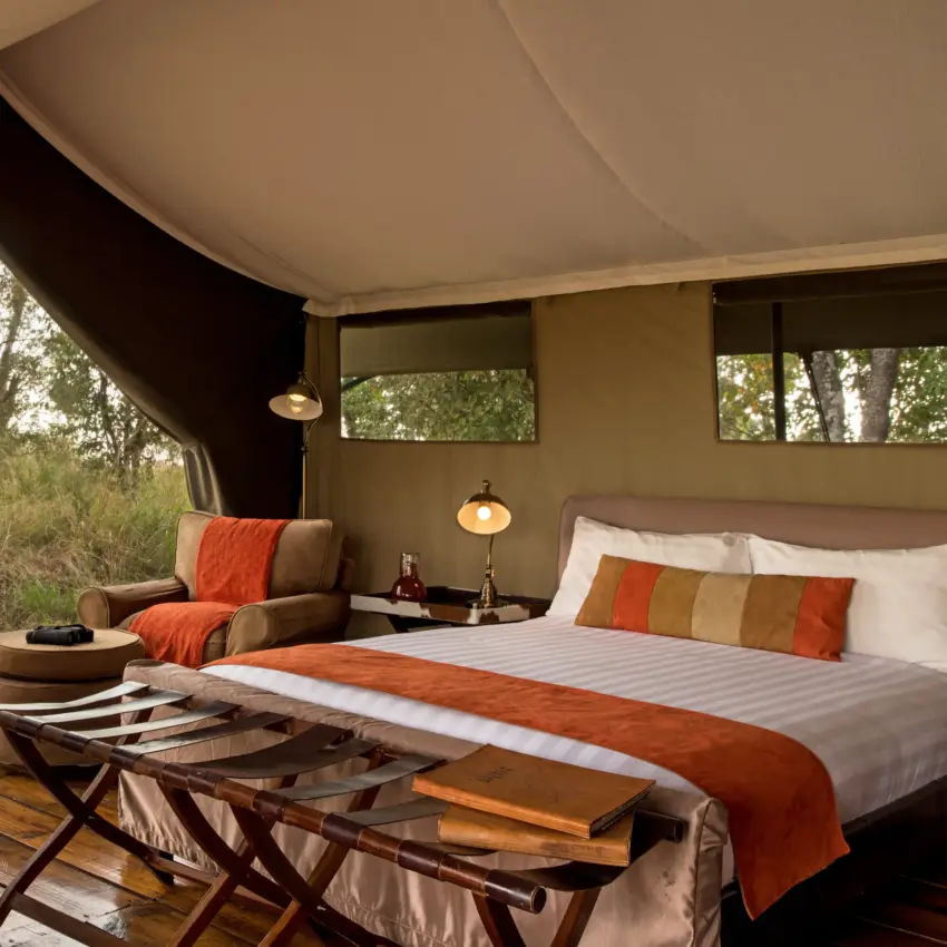 Luxury safari tent bedroom with canvas walls and savanna views, Ndutu Mobile Tented Camp, Serengeti National Park, Tanzania