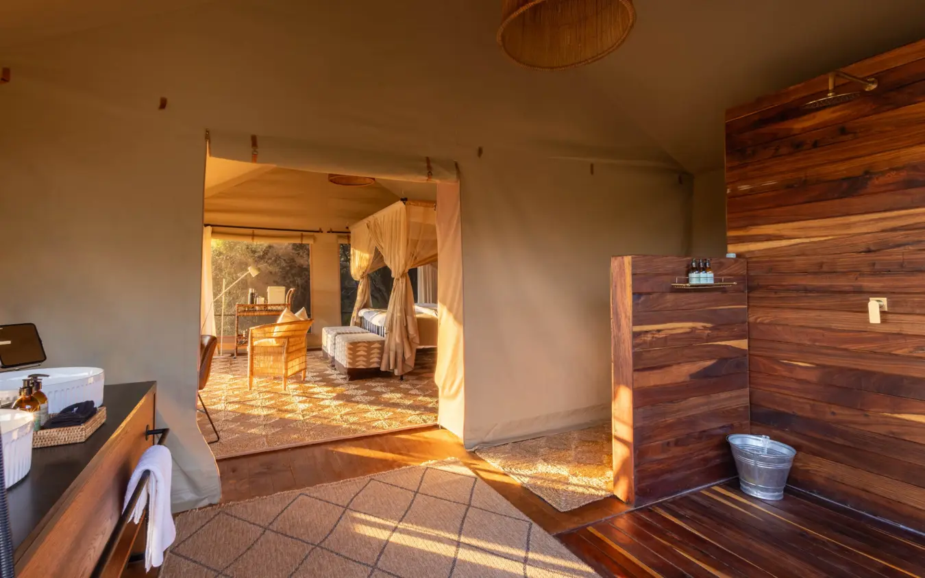 Luxury safari tent interior with wooden furnishings and natural sunlight, Nkasa Linyanti, Zambezi Region, Namibia