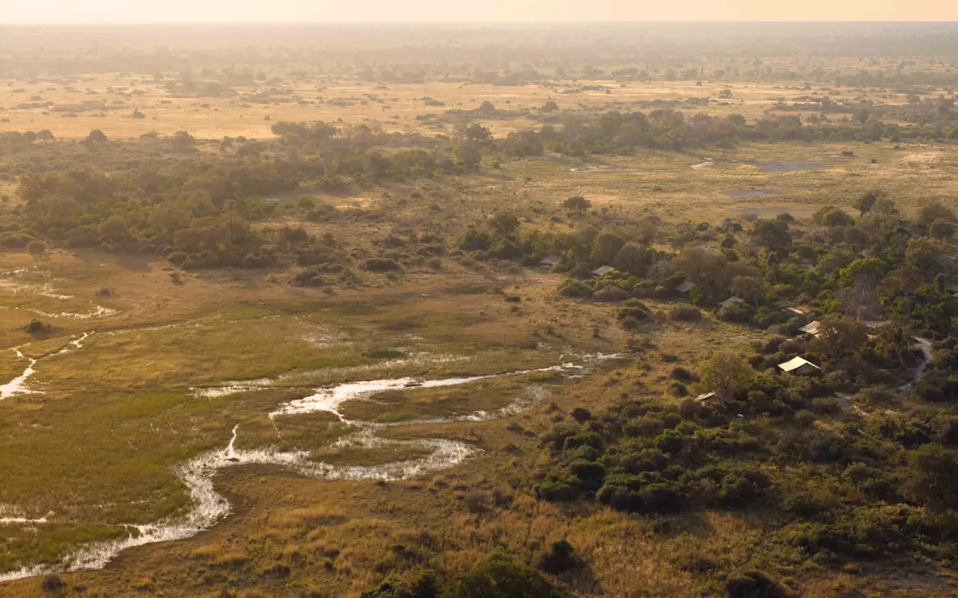 Aerial view of winding river through savanna woodland with scattered settlements, Nkasa Linyanti, Zambezi Region, Namibia