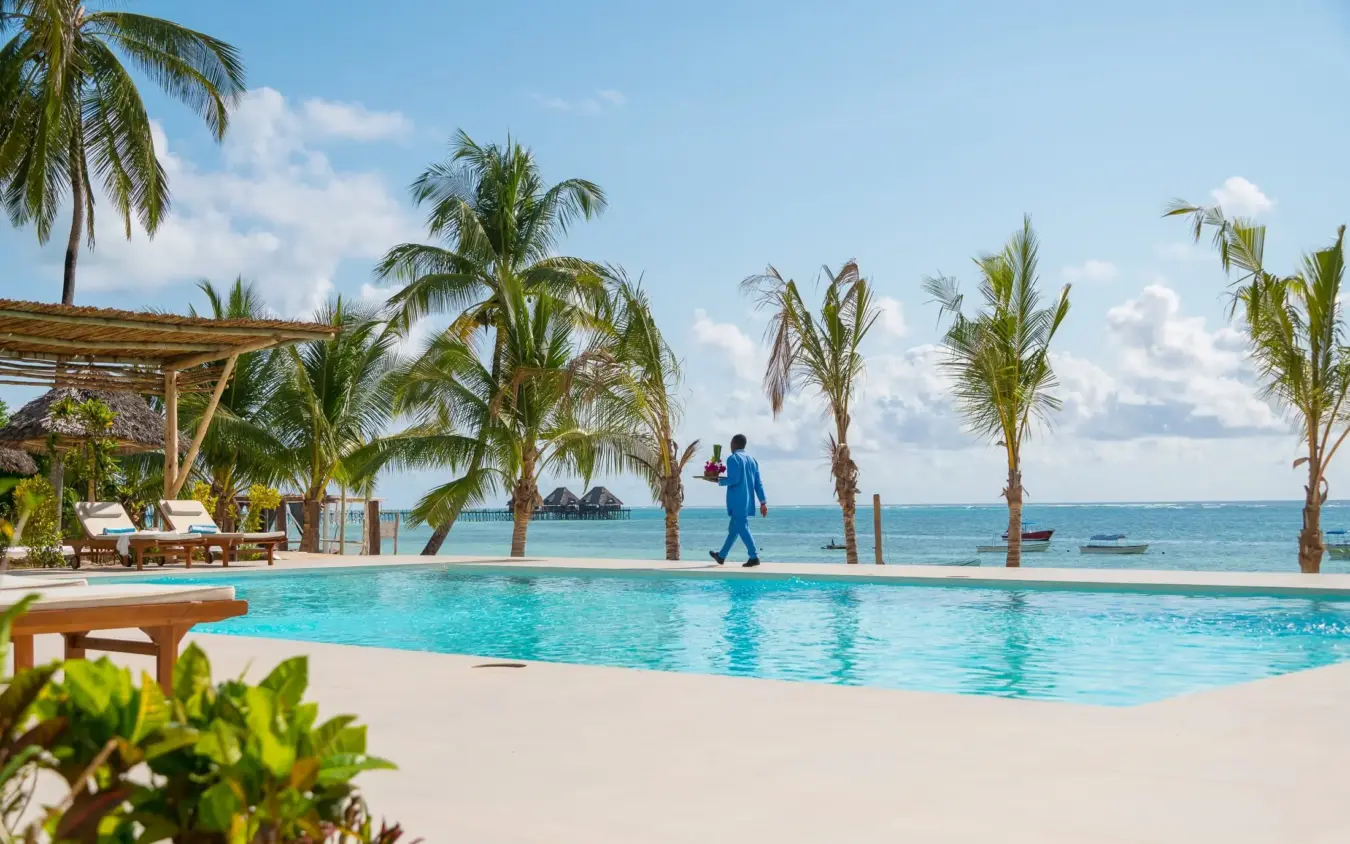 Resort pool with palm trees overlooking tropical ocean, Ocean Boutique Hotel, Zanzibar & Pemba, Tanzania