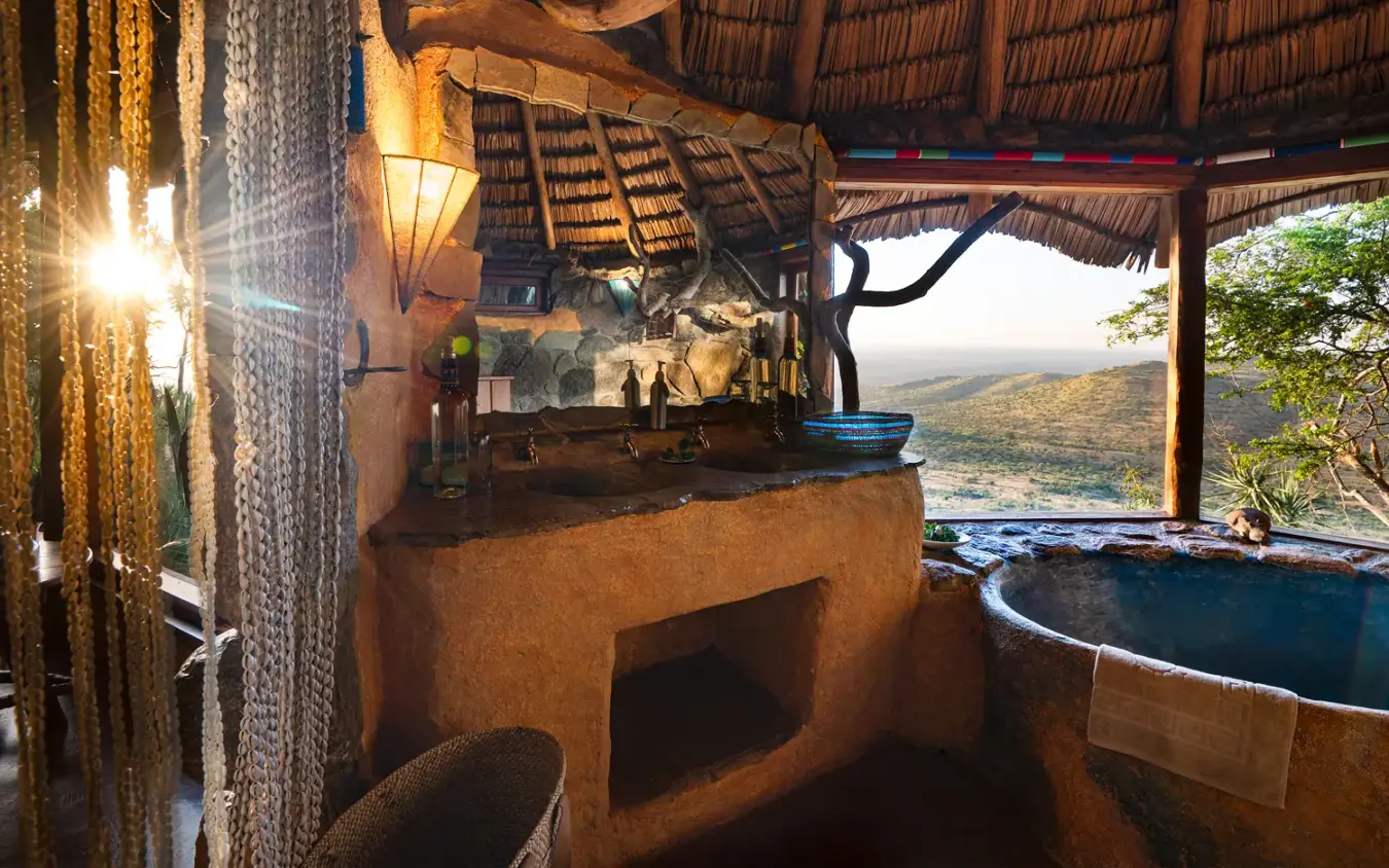 Outdoor bathroom with clay basin and valley view from thatched shelter, Ol Malo House, Laikipia Highlands, Kenya