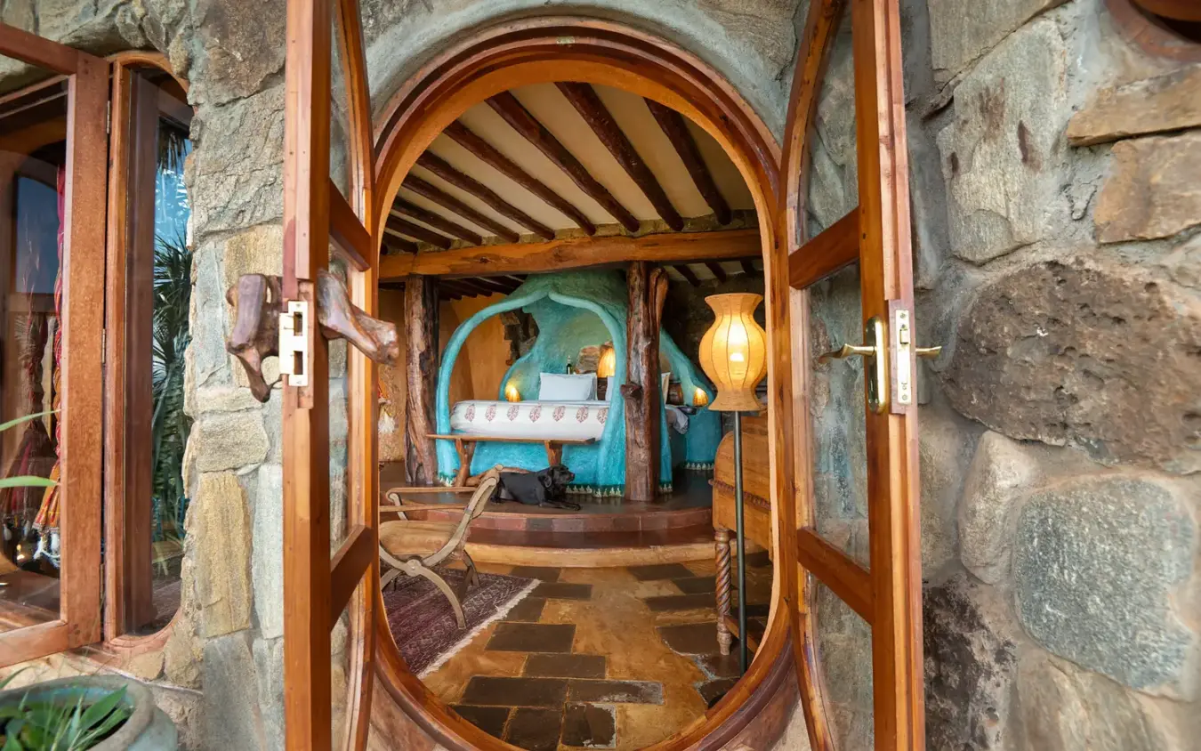 Spa room with turquoise bath and wooden beamed ceiling in stone lodge, Ol Malo House, Laikipia Highlands, Kenya