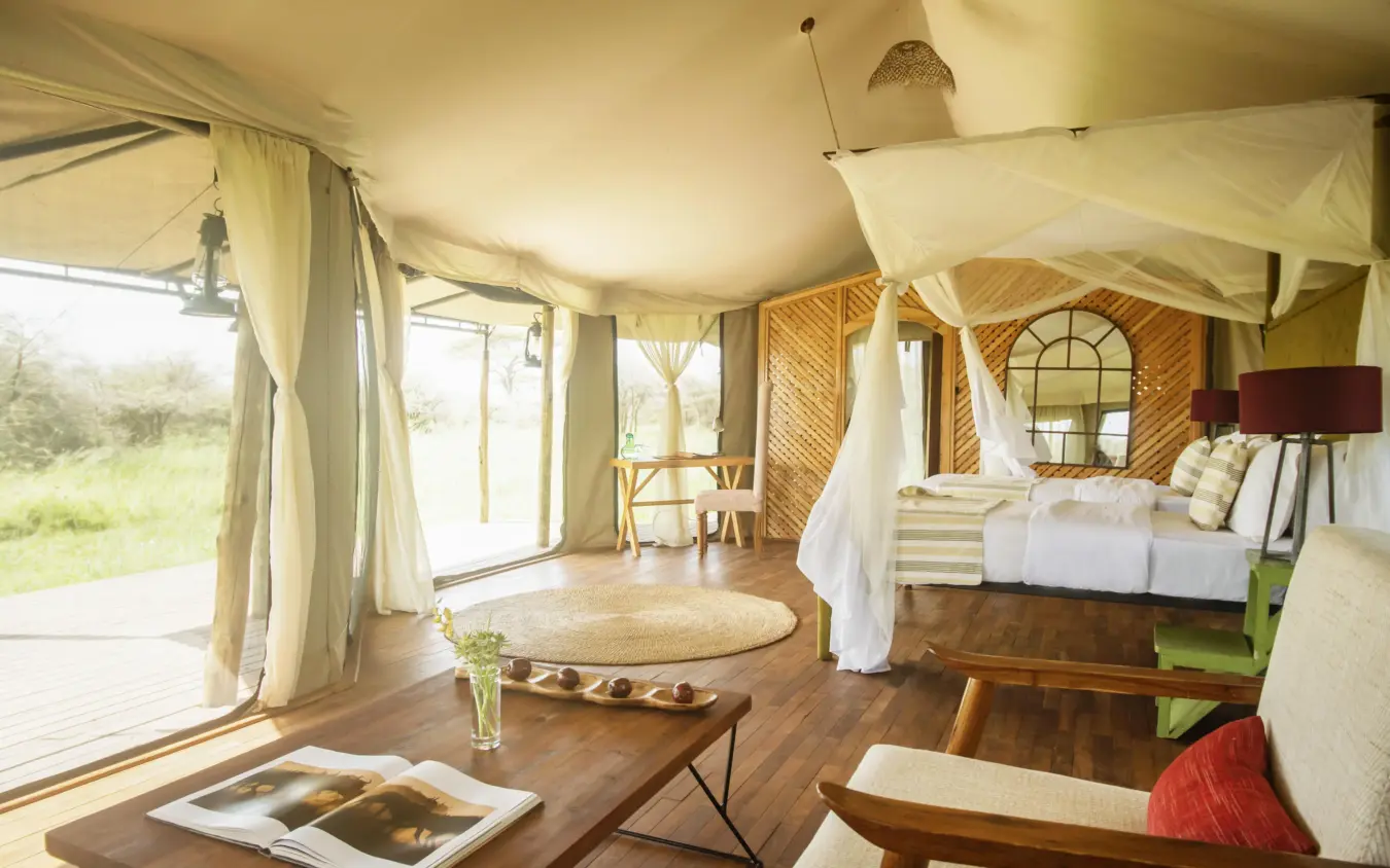 Spacious safari tent bedroom with canvas canopy and views, Olmara Serengeti, Serengeti National Park, Tanzania