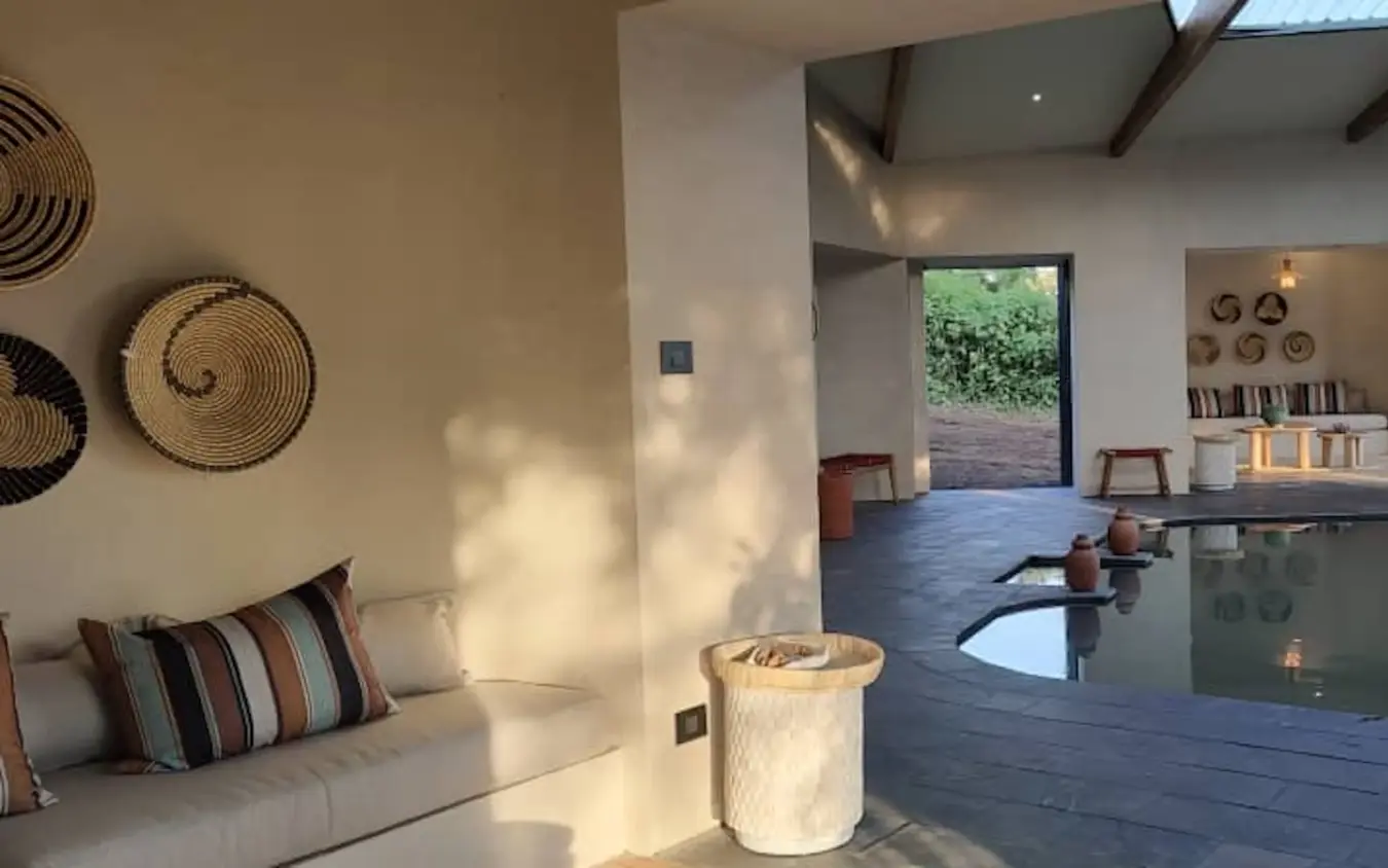 Contemporary safari lodge interior with woven wall art and natural light, Osonjoi Lodge, Ngorongoro Crater, Tanzania