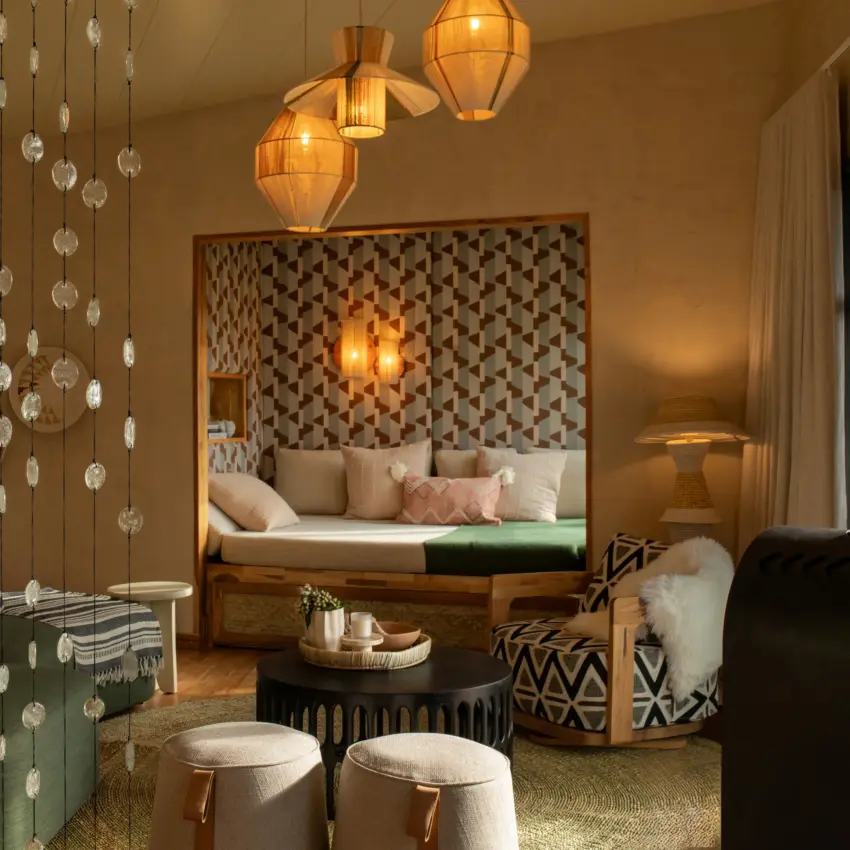 Luxurious bedroom suite with beaded curtain partition and ambient lighting, Osonjoi Lodge, Ngorongoro Crater, Tanzania