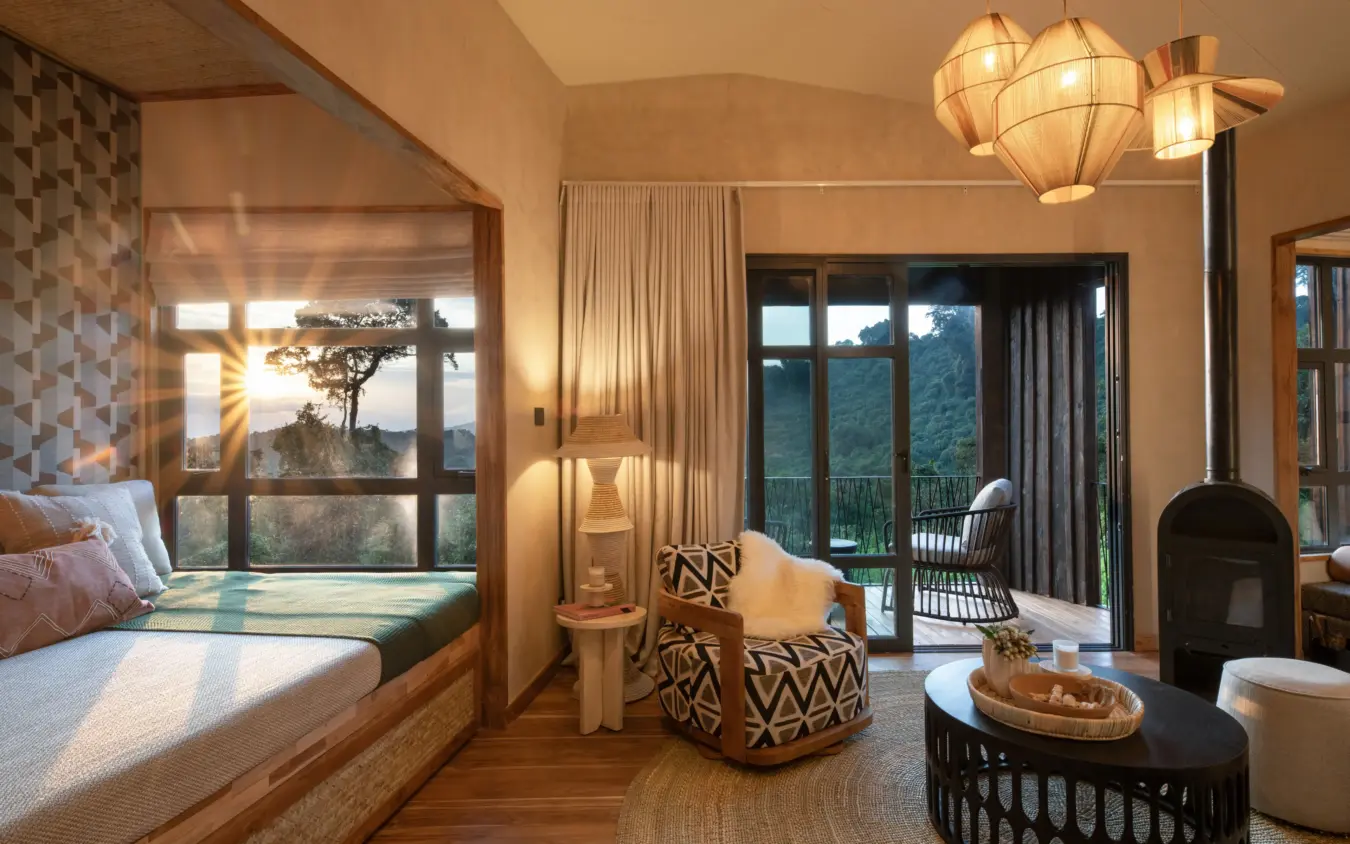 Luxury bedroom suite with mountain views and private terrace fireplace, Osonjoi Lodge, Ngorongoro Crater, Tanzania