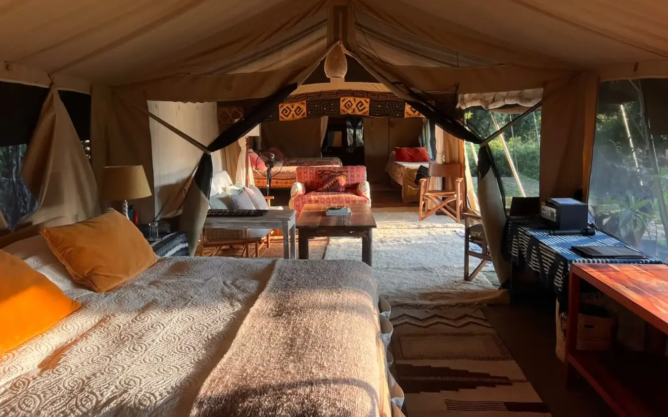 Spacious canvas safari tent interior with beds and lounge area, Roca River Camp, Maasai Mara, Kenya