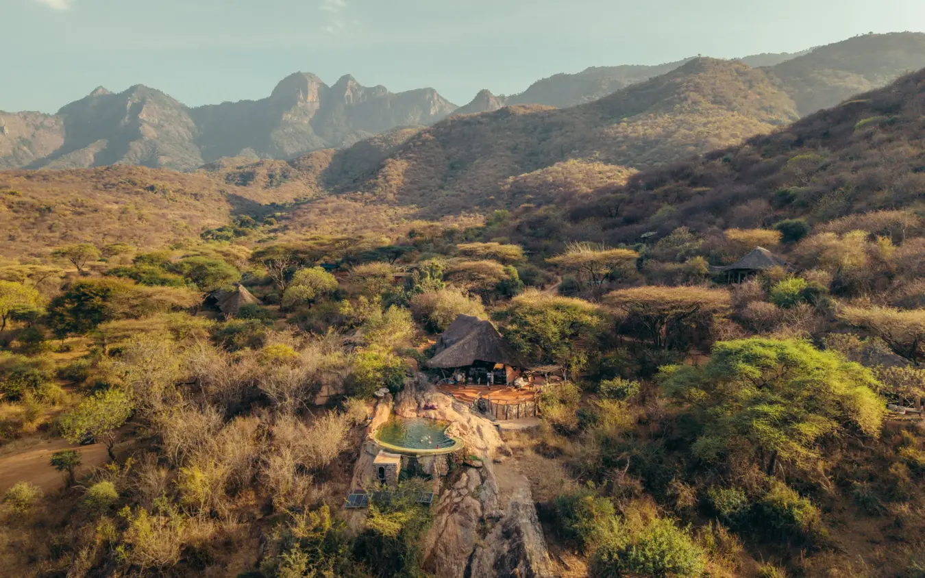 Luxury lodge perched on rocky outcrop overlooking acacia woodland valley, Sarara Camp, Northern Kenya, Kenya