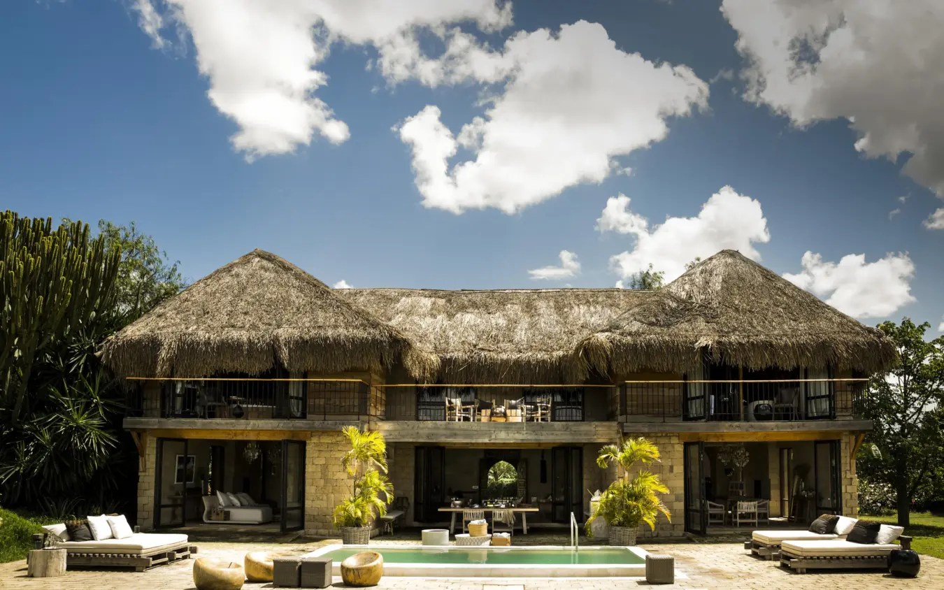 Modern lodge building with thatched roof and pool, Segera, Laikipia Highlands, Kenya