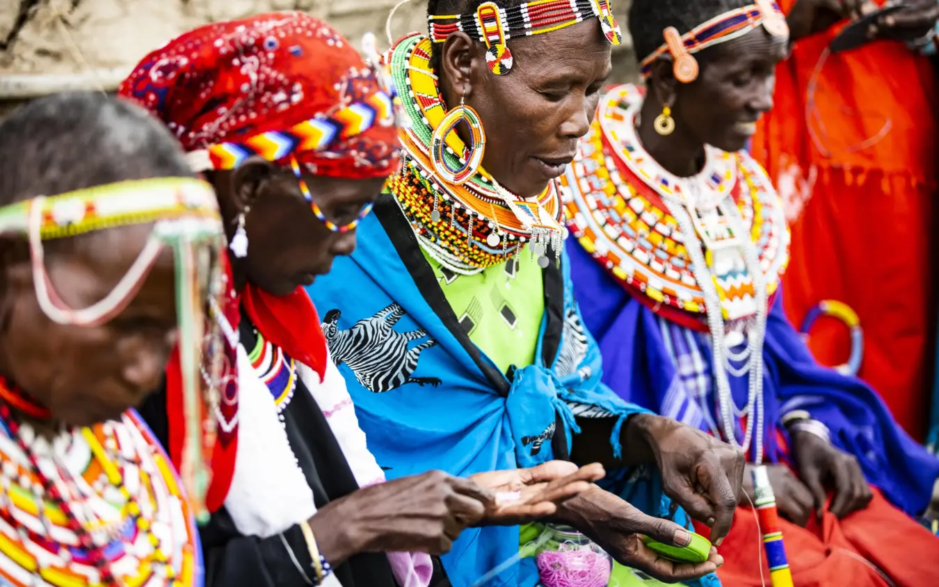 Maasai women in traditional beaded jewelry and colorful clothing, Segera, Laikipia Highlands, Kenya