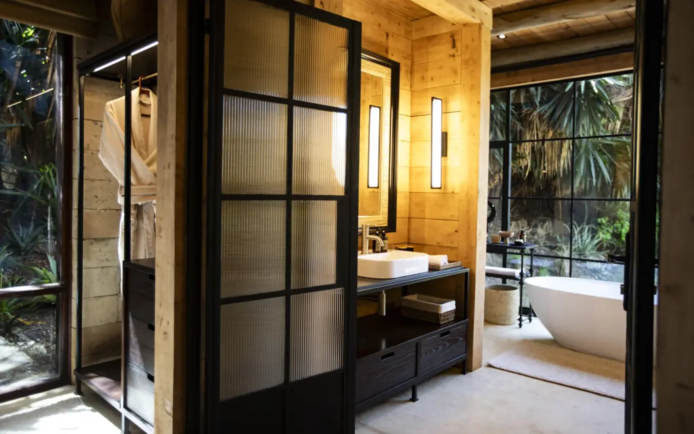Luxury bathroom with freestanding tub and open views to tropical garden, Segera, Laikipia Highlands, Kenya