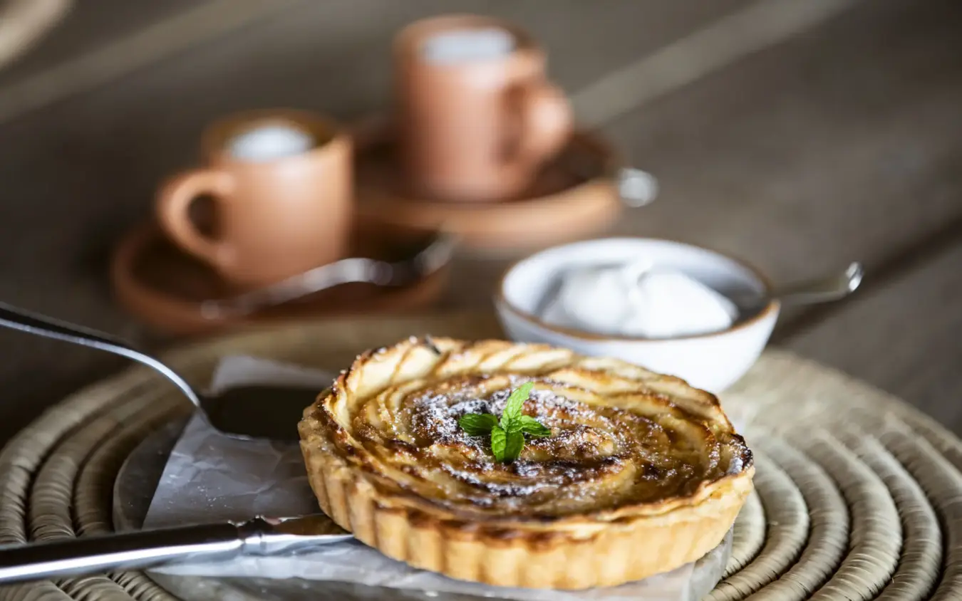 Plated dessert tart with coffee service on outdoor table, Segera, Laikipia Highlands, Kenya