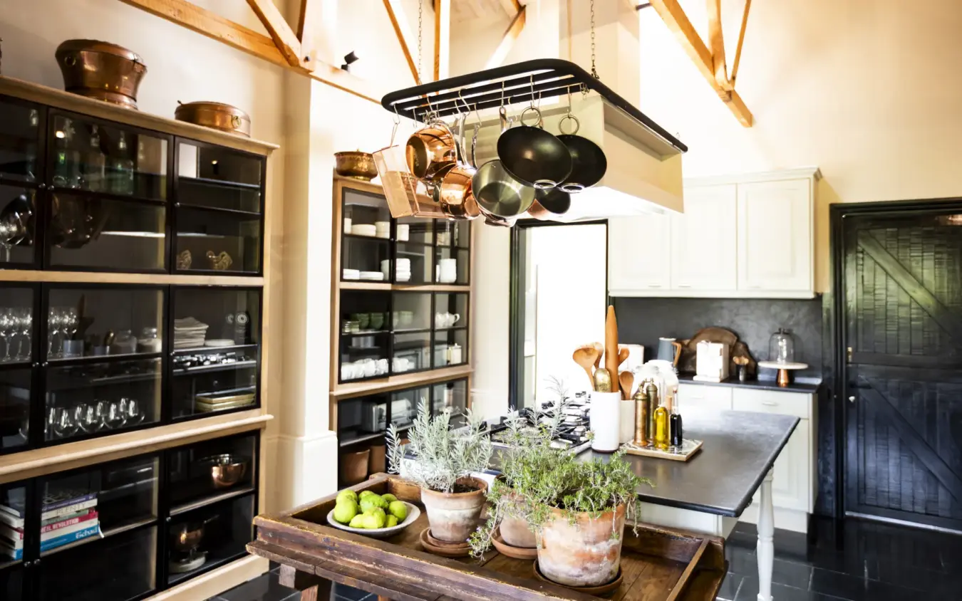 Modern kitchen interior with black cabinetry and wooden accents, Segera, Laikipia Highlands, Kenya