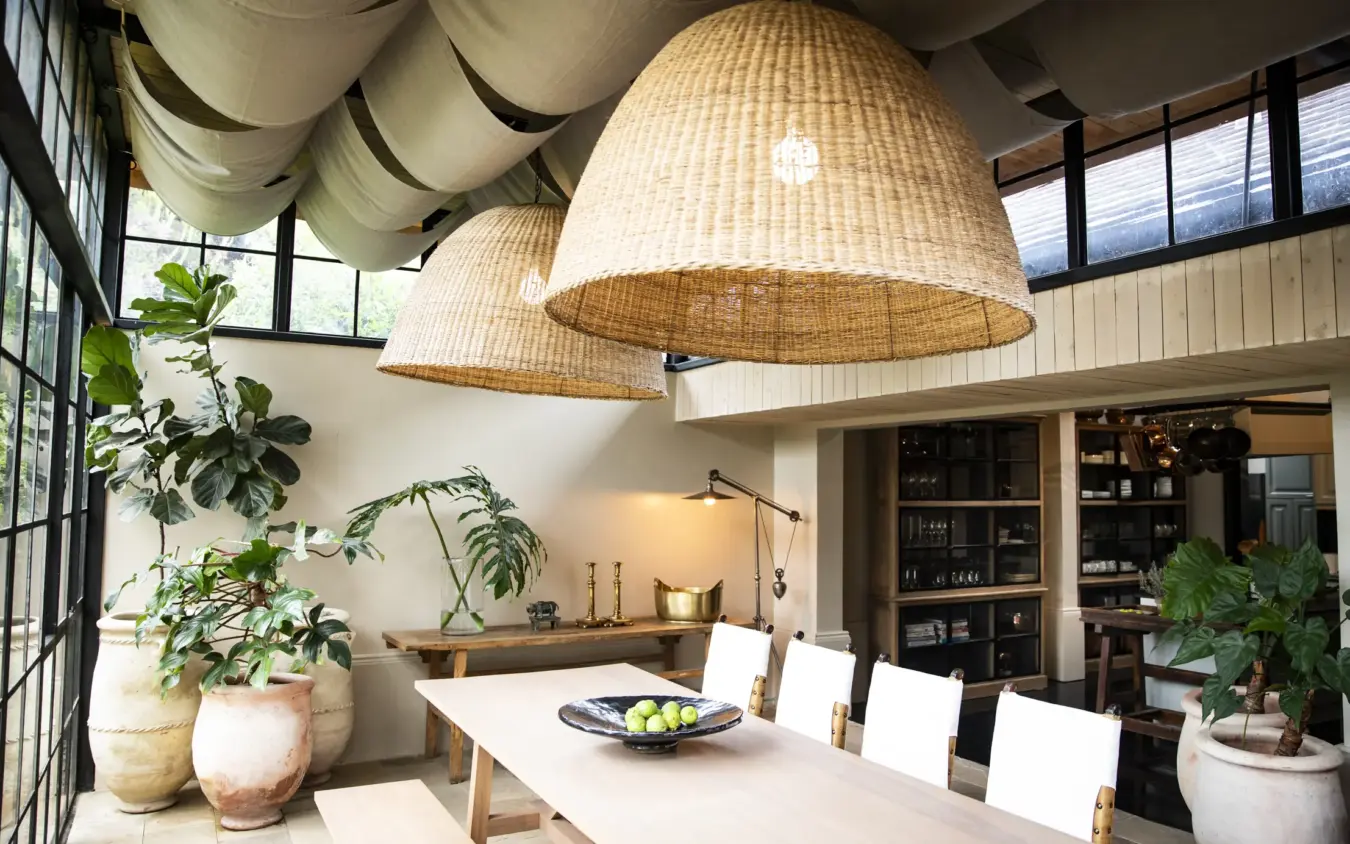 Contemporary dining space with woven pendant lights and potted plants, Segera, Laikipia Highlands, Kenya